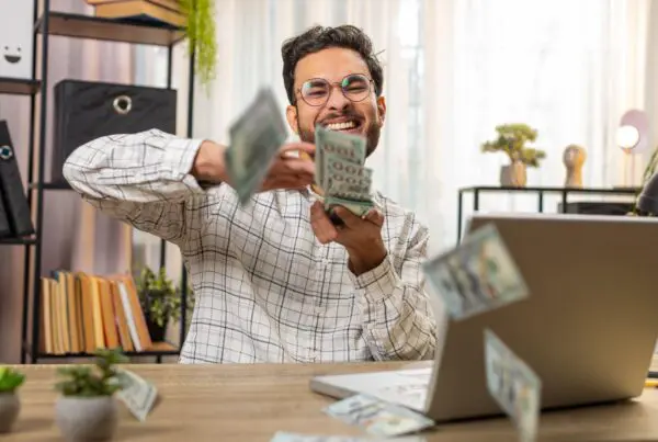 man happily shuffling money
