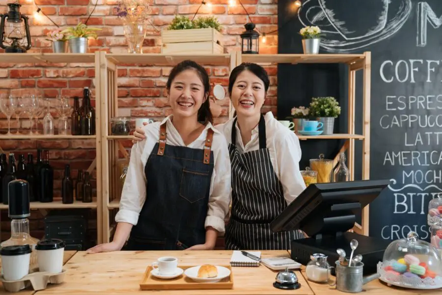 two female workers hugging each toher
