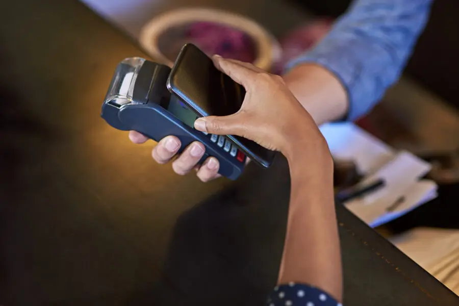 Phone, bill or hands of customer in coffee shop for fintech or nfc payment transaction closeup. Contactless machine, bank app or person in cafe or restaurant for transfer in small business startup