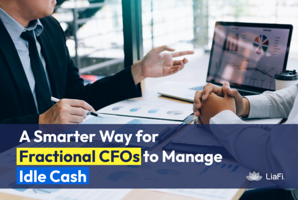 Fractional CFO reviewing financial reports and charts while explaining how to manage idle business cash more efficiently.
