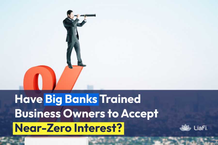 Businessman looking through a telescope at a large interest rate symbol representing how banks keep business interest rates near zero.