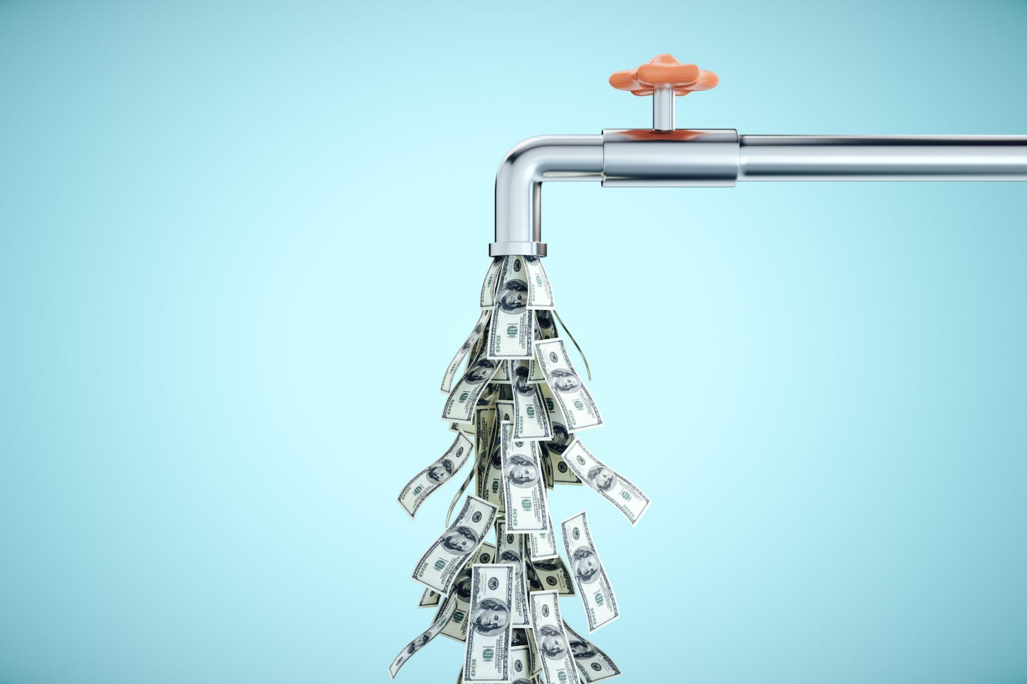 a faucet with money coming out of it