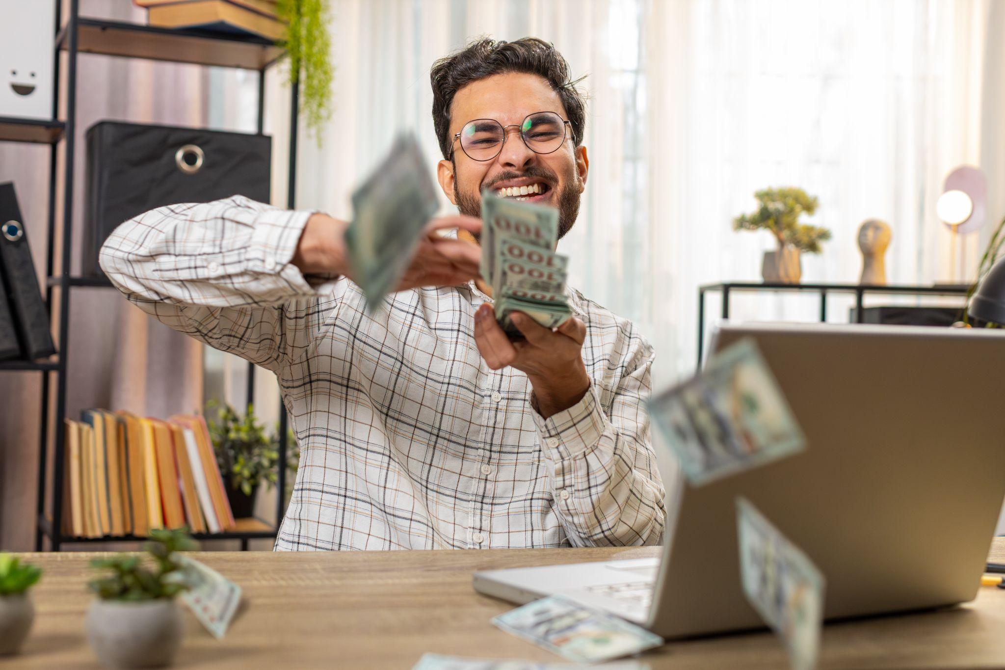 man happily shuffling money